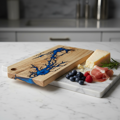 Wooden cutting board with blue resin design on a marble surface with food items.